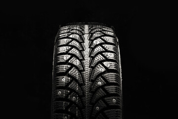 winter studded tire new photo from the front on a black background close-up
