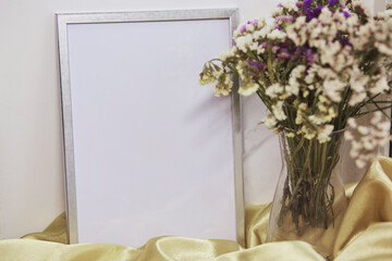 Minimalist mockup wall frame and vase with dried flowers. Place for text or advertising.