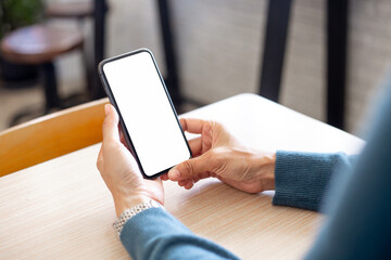 cell phone blank white screen mockup.hand holding texting using mobile on desk at office.background empty space for advertise.work people contact marketing business,technology