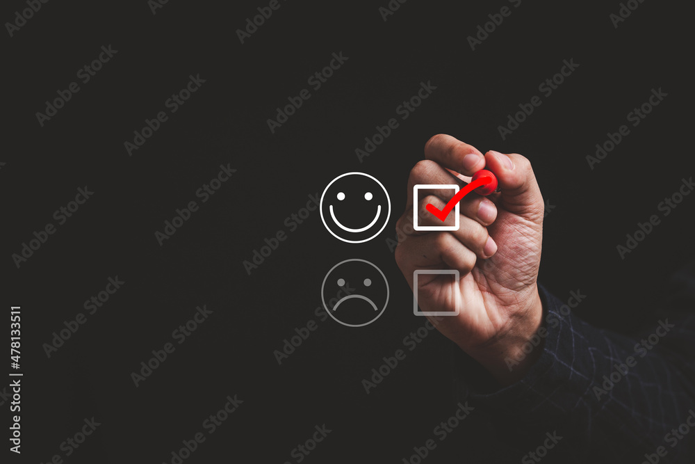 Poster Hand tick red mark to select smile face for happiness mindset and positive evaluation after use product and service concept.