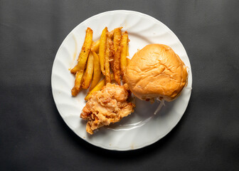 Fresh crispy chicken burger with cheese, tomatoes and lettuce on wood table, American fast food.