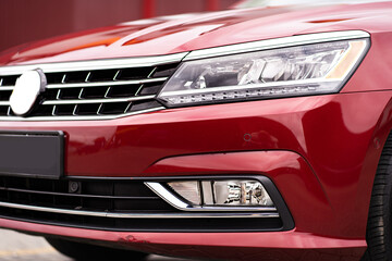 Close up detail on one of the red car taillight modern red crossover car. Exterior detail business automobile.