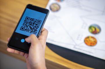 Curly-haired businessman choosing lunch menu and ordering online