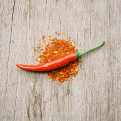 Red chilli pepper with cayenne pepper  on wood desk  