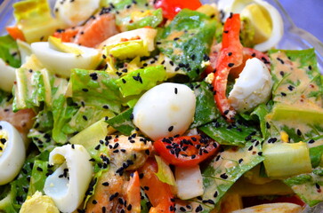 Close-up shot of a salad with seafood and vegetables.