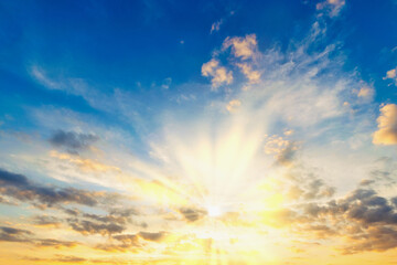 Naklejka na ściany i meble Sky blue and orange light of the sun through the clouds in the sky