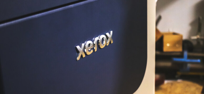 Xerox Logo Close-up. Large High Volume Printer In Print House Workshop