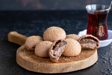 Fig cookies on a dark background. Cookies filled with fig marmalade. Close-up. Horizontal view