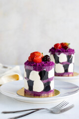 Forest fruit mini cake on a white background. Close-up. Vertical view