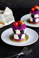 Forest fruit mini cake on a dark background. Close-up. Vertical view