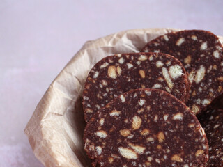 biscuit cake with pine nuts on a beige background close-up