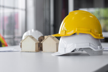 Yellow hard hat on desk work spec for engineering design , Safety helmet engineer, Background for...