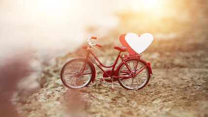 bike is parked and there is a heart shape on top. concept of love of lovers on Valentine's Day, Red bicycle love