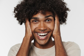 Young black man with piercing laughing while holding his head