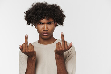 Young black man with piercing frowning while showing middle fingers