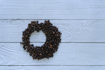 Coffee beans isolated circle on white wooden background