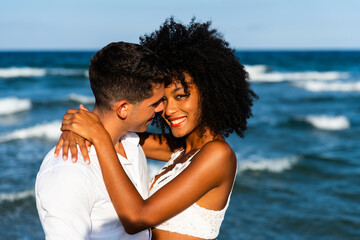 Young romantic couple having embracing fun time in the beach.