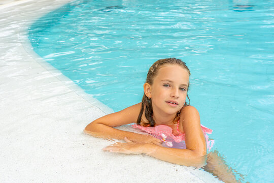 Beautiful little girl posing in the pool. Hight quality photo