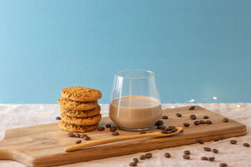 Latte with cookies on wood standing and coffee beans. Isolated background