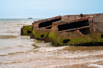 Fototapeta na wymiar Remains of military artificial port from the world war and landing of allies in Arromances, Normandy, France