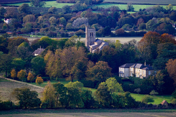 Church seen from afar in autumn scene in small village 