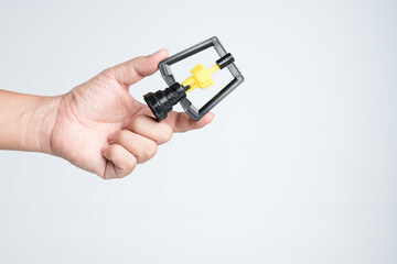 Hand holding modern rotating water plastic sprinklers