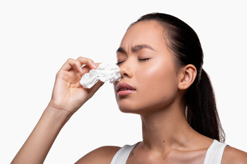 Young asian woman suffering with nasal bleeding, free space