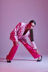 Sexy brunette woman luxury clothing fashion plaid blazer pink background unaltered