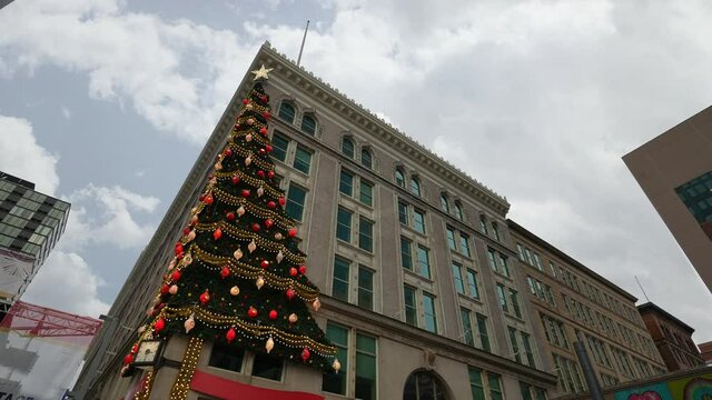 PITTSBURGH - Circa December, 2021 - A low angle daytime view looking up at a Christmas tree on the side of a building in downtown.  	