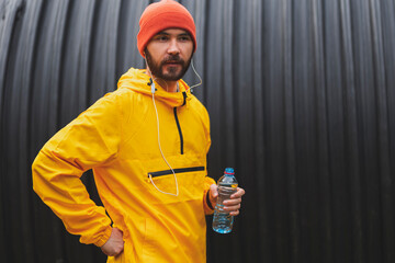 Man drinking water and relaxing after morning run