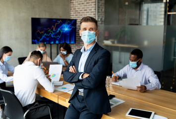 New Normal In Office. Company Ceo Wearing Medical Mask Posing In Boardroom
