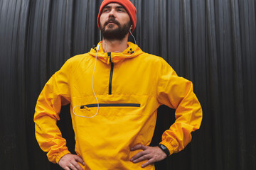 Active man wearing headset listening to music while working out outdoors
