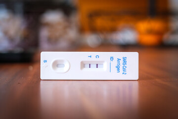 on a table there is a positive Corona rapid test