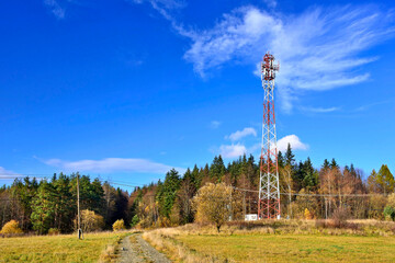 Communication antennas, radio telephone mobile phone antennas on blue sky. Tower connection with...