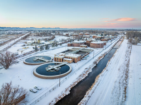 Aerial view of industrial area of Fort Collins, Colorado with a waste water treatment plant, winter scenery at dusk