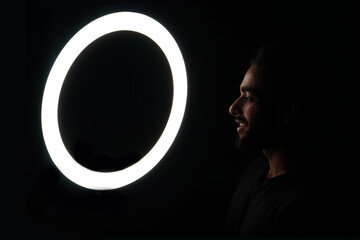 Young boy watching in ring light low light images