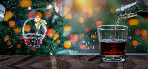 a glass of whiskey and wine on wood bar, romantic dinner setting.	