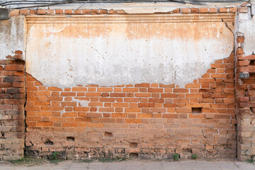 Old brick wall with cracked concrete. Vintage red brick wall.