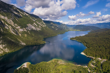Aerial view on Bohinj lake between mountains with forest in Slovenia, Europe