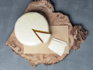 farm cheese on wooden stand on gray background - 478158543