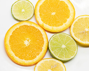 Fototapeta na wymiar Citrus fruit slices in a white plate