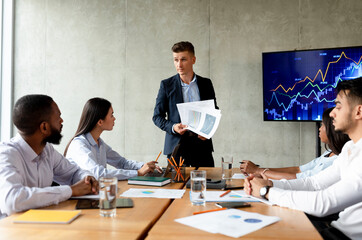 Business Problems. Disappointed Boss Showing Financial Reports To Workers During Corporate Meeting