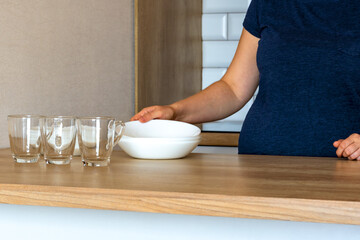 woman puts the plates . Kitchen, Dishwasher. plates,