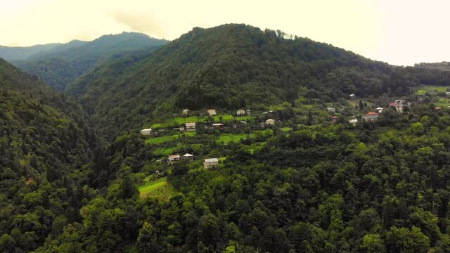 Aerial View Drone View: Flying over a mountain village with forests, fields and vineyards. Cinematic Drone Shot of a Hilly Place. East of Georgia, Europe. Majestic landscape. World of beauty. 4K