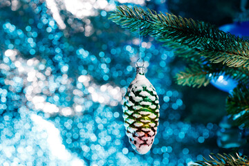 Obraz na płótnie Canvas Christmas decoration on a branch of a Christmas tree with blue lights