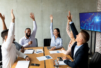 Business Training. Group Of Happy Colleagues Raising Hands At Meeting In Office