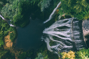 Big waterfall. Top view of water drop from drone. Waterfall Marmore, Cascata delle Marmore, in Umbria, Italy. The tallest man-made waterfall in the world.