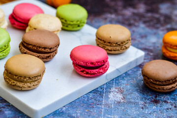Fototapeta na wymiar Selection of colorful french macaroons on industrial background . Patisserie Banner