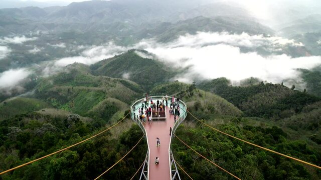 Skywalk Aiyerweng Famous landmark in Betong Yala southern thailand - Many tourist walking to see fog misty in the morning with green nature hill mountain - 4k VDO