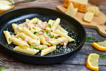  Fresh home made italian  penne  pasta   alla carbonara with  cream sauce  ,  bacon,egg, parmesan cheese ,olive oil and black pepper) 